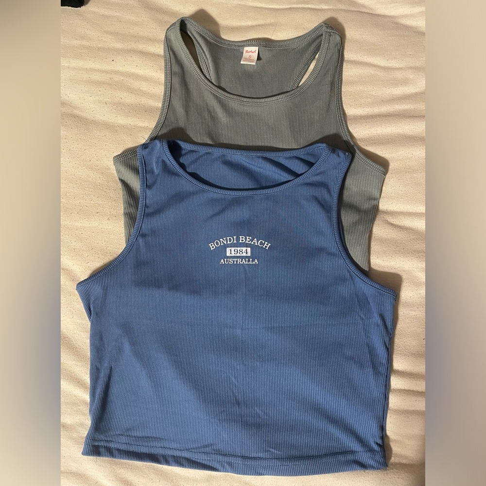 Two sport material tank tops, both small